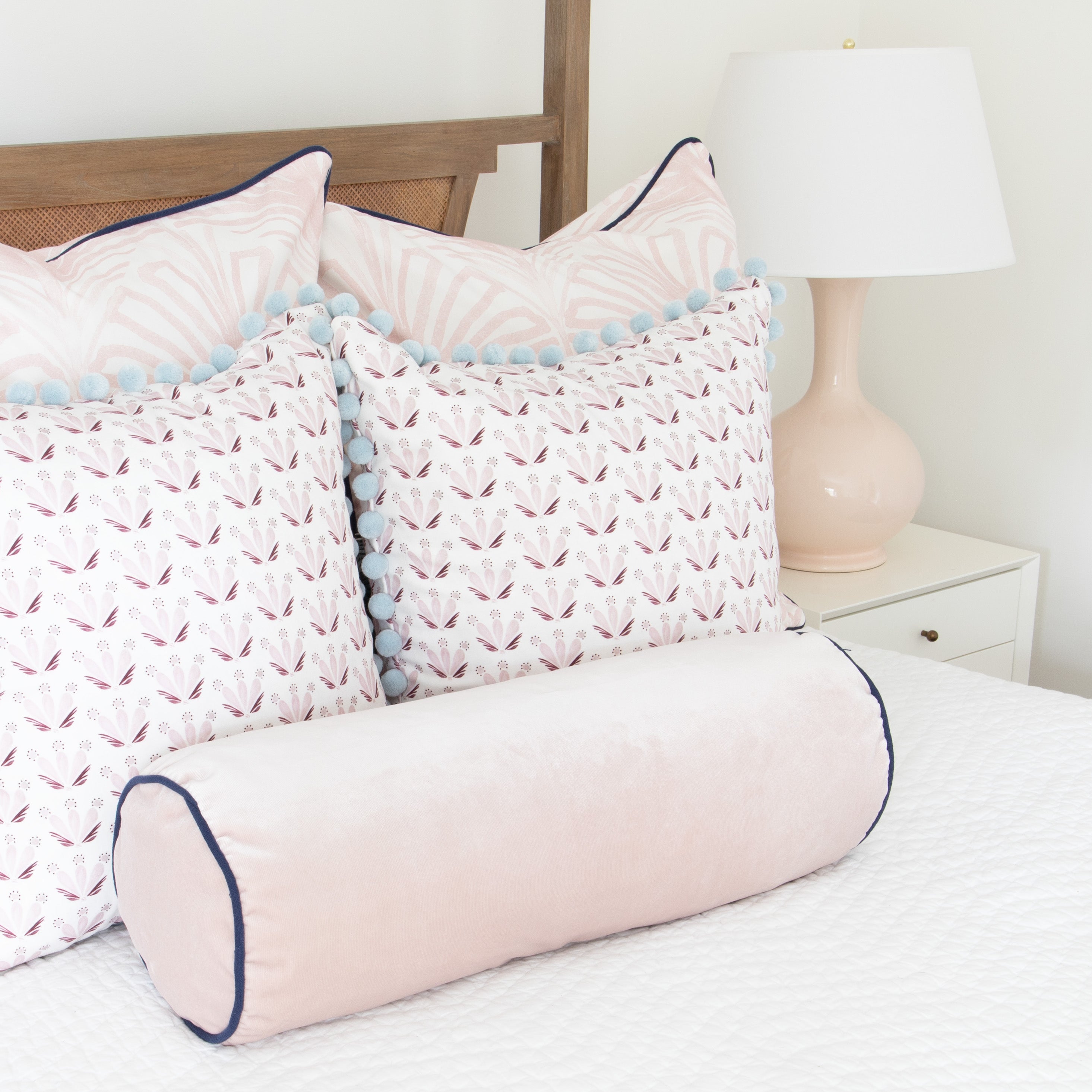 Rose made-to-order decorative pillows and bolster in soft pink with blue pom trim, manufactured in the USA with short lead times